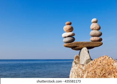 Concept of harmony and balance. Balance and poise  stones against the sea. Rock zen in the form of scales