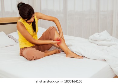 Concept Health Care And First Aid : The Woman Sat With Acute Thigh Muscle Pain From Cramping While She Slept In Bed, And She Was Doing A Massage To Relax Her Muscles : Selective Focus