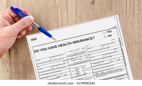 Concept Of Health Insurance Coverage, Increase Price Of Health Policies, Lack Of Health Coverage With A Patient Filling A Medical Test Form Asking If He Has Health Insurance