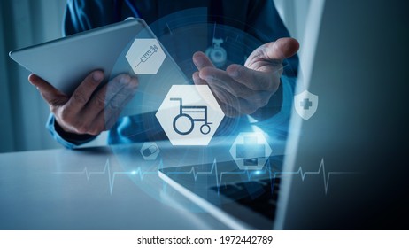 Concept Of Health Insurance For People With Disabilities. Doctor Advises The Disabled, The Wheelchair Sign On The Virtual Screen, Health Care Assistance For Life Safety.