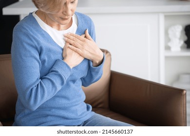 Concept Of Health Problems, Cardiovascular And Cardiac Disease. Cropped View Of Mature Woman Feeling Heart Pain And Chest Tightness, Trying To Relieve Symptom Of Arrhythmia