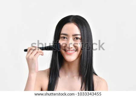 The concept of healthy beautiful woman. Beautiful girl Make up with cosmetics. Beautiful women use cosmetics suitable for the face. Beautiful woman makeup on isolated background