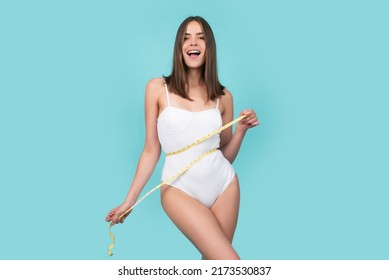 Concept of healthy eating and dieting. Woman with thin waist, loose waist, measuring tape.