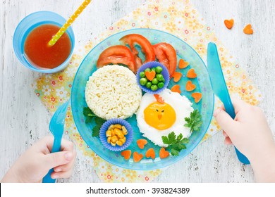 Concept Of Healthy Food For Child. Food Art Idea For Kids Breakfast Egg And Vegetable Garnish Tomato Juice Top View