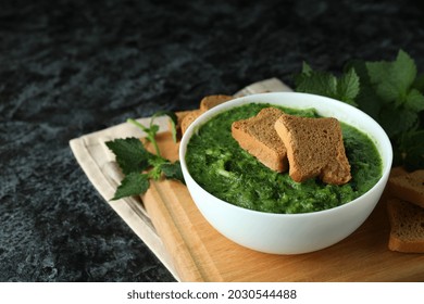 Concept Of Healthy Food With Nettle Soup On Black Smokey Table