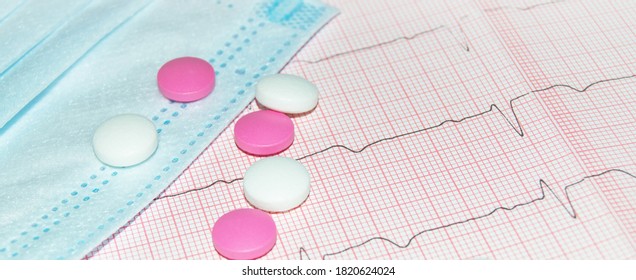 Concept Of A Healthy Heart With A Cardiogram, Mask And Pills, Top View, Cardiac Care. Concept Of Cardiology, Medicine And Insurance.