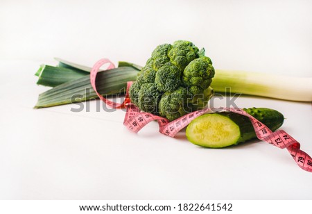 concept of healthy lifestyle, eating loosing weight presented by green vegetables such as broccoli, leek for  being healthy and slim
