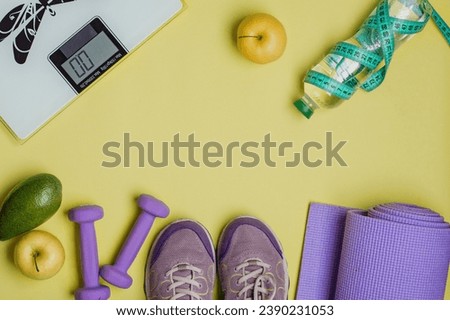 The concept of a healthy lifestyle, exercise, water balance, nutrition, regimen. Sports equipment on a bright yellow background, top view, horizontal, copy space.