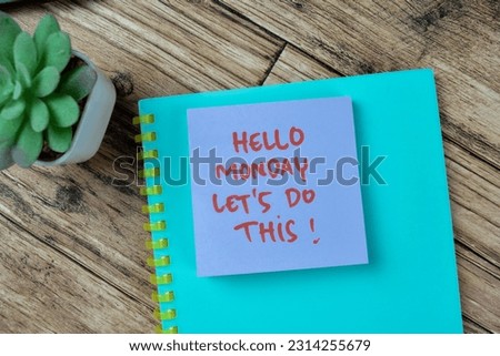 Concept of Hello Monday Let's Do This! write on sticky notes isolated on Wooden Table.