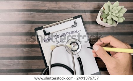 Concept of High Colesterol write on paperwork isolated on wooden background.