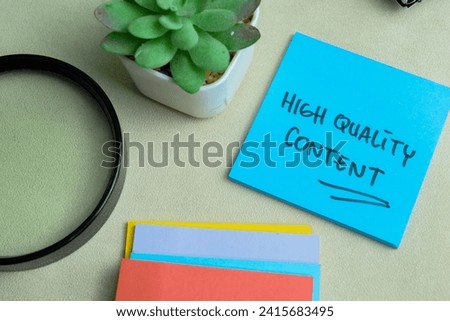 Concept of High Quality Content write on sticky notes isolated on Wooden Table.