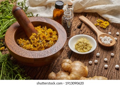 concept of homeopathic pills in a wood spoon and bottles with the herb in a mortar with a pestle on wood background. aroma, Homeopathy                                                     
