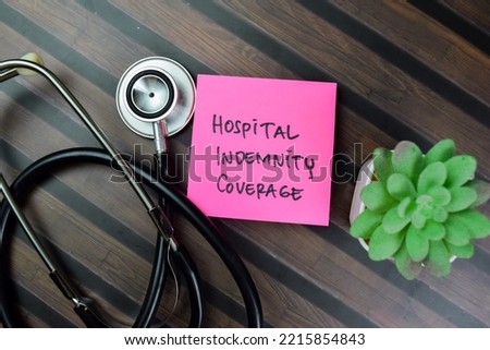 Concept of Hospital Indemnity Coverage write on sticky notes isolated on Wooden Table.