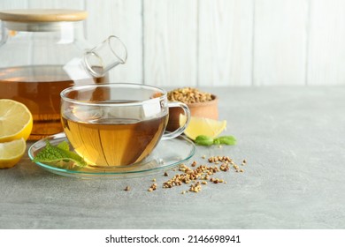 Concept of hot drink with buckwheat tea on gray textured table