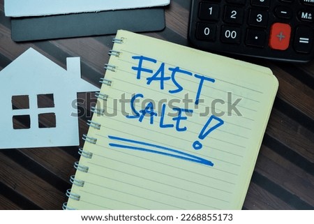 Concept of House Fast Sale write on book isolated on Wooden Table.