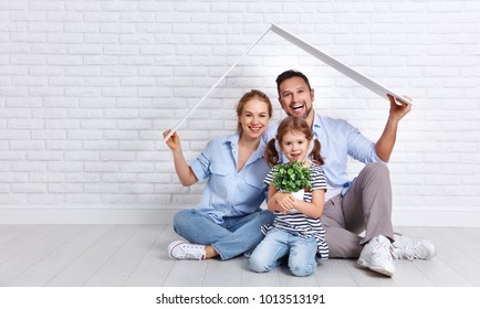 concept housing a young family. Mother father and child in new house with a roof at empty brick wall