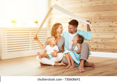 Concept Housing A Young Family. Mother Father And Children In A New Home
