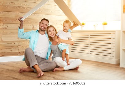 concept housing a young family. Mother father and child in new house with a roof