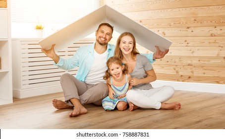 Concept Housing A Young Family. Mother Father And Child In New House With A Roof
