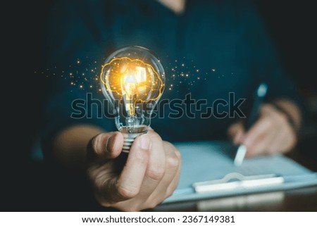 Concept Idea and Artificial Intelligence. AI, machine learning, Abstract, People holding Glowing colorful brain circuit in light bulb processing, deep learning, innovation Science and technology.