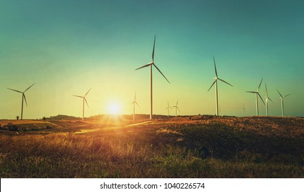 Concept Idea Eco Power Energy. Wind Turbine On Hill With Sunset