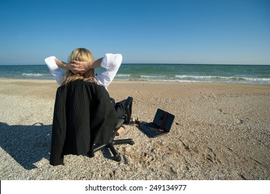 Concept Illustrating Remote Work, Business Woman With Laptop And Office Chair On The Beach