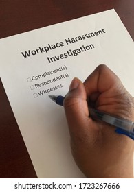 A Concept Image Of A Black Person Completing A Form With The Words Workplace Harassment Investigation, Complainant, Respondent, And Witnesses On It