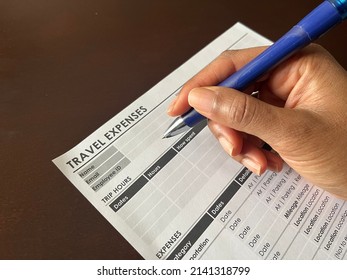 A Concept Image Of A Black Person Completing A Travel Expense Form