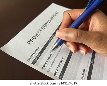 A Concept Image Of A Black Person Completing A Project Status Report Form