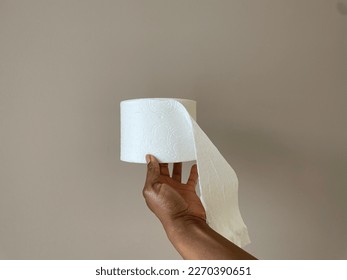 Concept image of a Black person holding a toilet paper roll