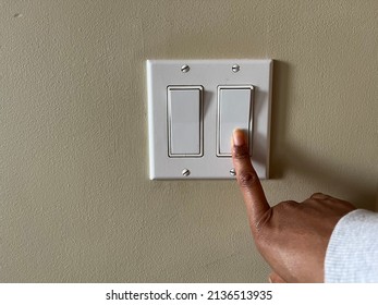 A Concept Image Of A Black Person Turning Off An Electrical Switch To Save Money 