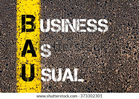 Concept image of Business Acronym BAU Business As Usual written over road marking yellow paint line