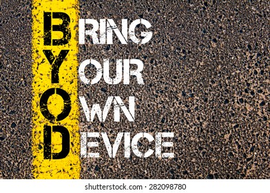 Concept image of Business Acronym BYOD as BRING YOUR OWN DEVICE written over road marking yellow paint line.