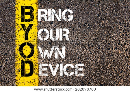 Concept image of Business Acronym BYOD as BRING YOUR OWN DEVICE written over road marking yellow paint line.