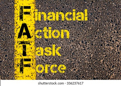 Concept Image Of Business Acronym FATF  As Financial Action Task Force Written Over Road Marking Yellow Paint Line.