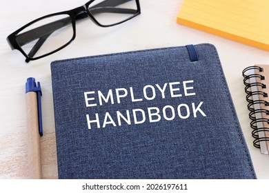 Concept Image Of Employee Handbook Over Wooden Office Table. Top View