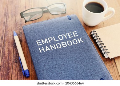 Concept Image Of Employee Handbook Over Wooden Office Table. Top View