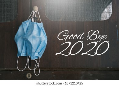 Concept image of end year 2020. Good bye 2020 image with face mask year of pandemic Covid-19