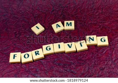 Concept image of I am forgiving in texture background image using by block letter for Motivational inspiration