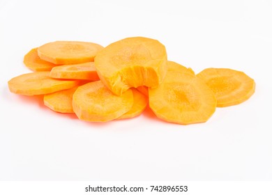 Concept image of fresh vegetable tips weight loss. Proper nutrition and healthy lifestyle. Orange-red carrot chopped slice rings macro view isolated on white background. - Shutterstock ID 742896553
