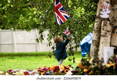 Concept Image For The Future Of The United Kingdom. A Child Holds The Flag Of UK In Hyde Park During The People Gathering For Queen Elizabeth II Funeral Day. London, 2022.