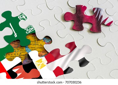 Concept Image Of Gulf Countries Unsolved Crisis. Jigsaw Puzzle Piece Of Qatar Flag Being Separated From Other Pieces Featuring Flags Of Saudi Arabia UAE Bahrain Egypt Yemen. Partly Seen Map.