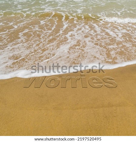 Concept image - to illustrate washing away stress by taking a vacation as waves on a sandy beach wash away the word 