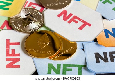 A concept image for investing in Non Fungible Tokens (NFTs) through Ethereum blockchain. These are rare digital items that are traded online. Image shows NFTs with ETH coins on dark background