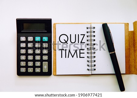 A concept image a note book with calculatorand a pen with a word Quiz Time