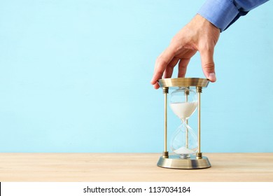 concept image of person holding hourglass. deadline and schedule concept  - Powered by Shutterstock