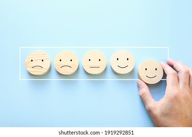Concept image of satisfaction level. wooden cubes with emotions
