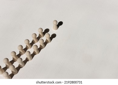 Concept Image Of Wooden Figures Forming A Wall. Leadership Teamwork And Strength Metaphor