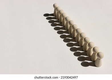 Concept Image Of Wooden Figures Forming A Wall. Leadership Teamwork And Strength Metaphor