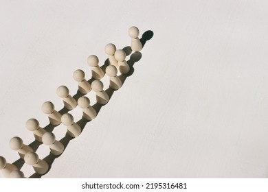 Concept Image Of Wooden Figures Forming A Wall. Leadership Teamwork And Strength Metaphor